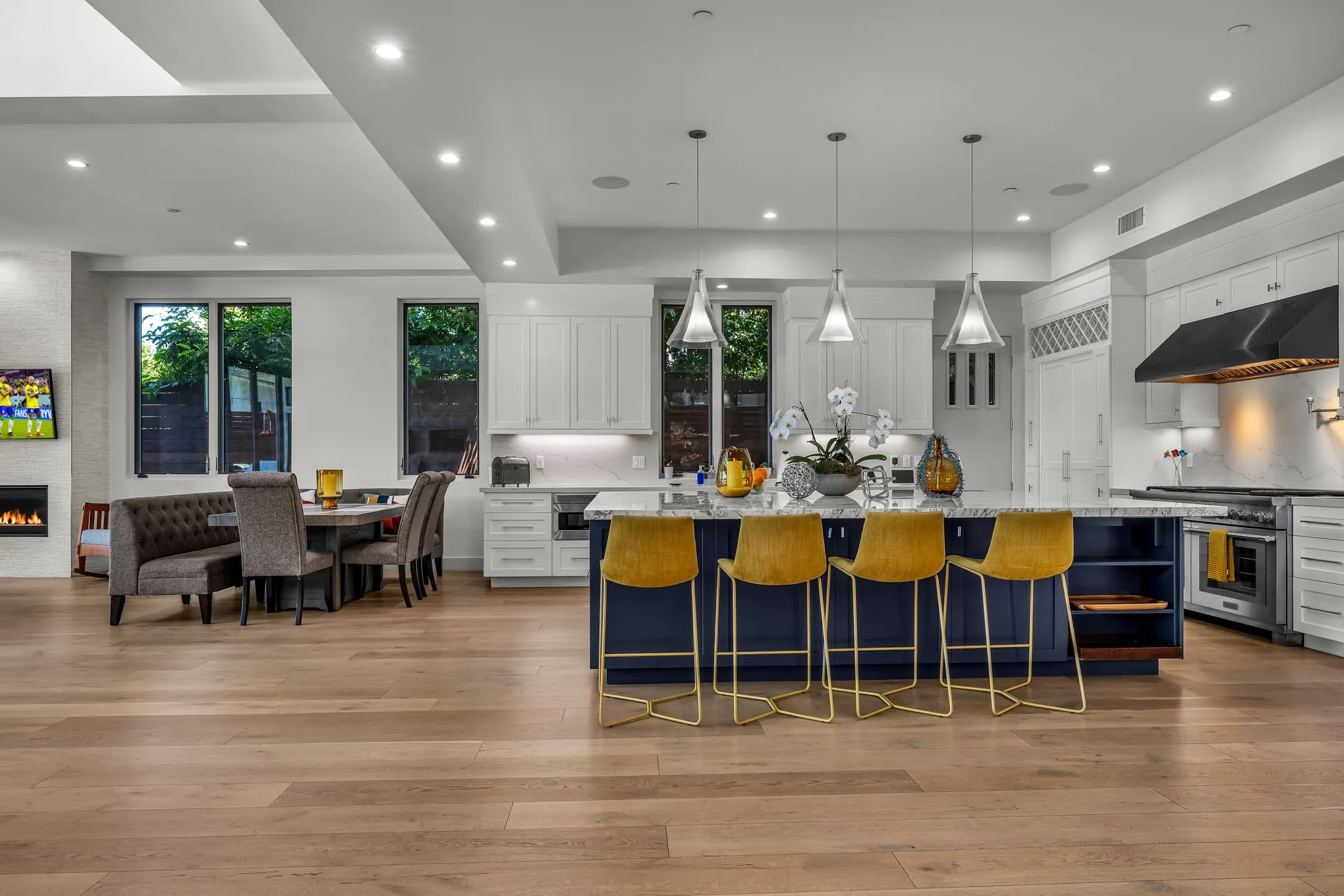 Expansive chef’s kitchen with an oversized navy island and bar seating