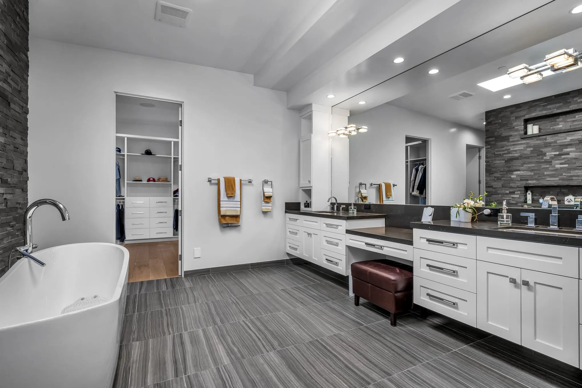 Primary bathroom with double vanity and soaking tub